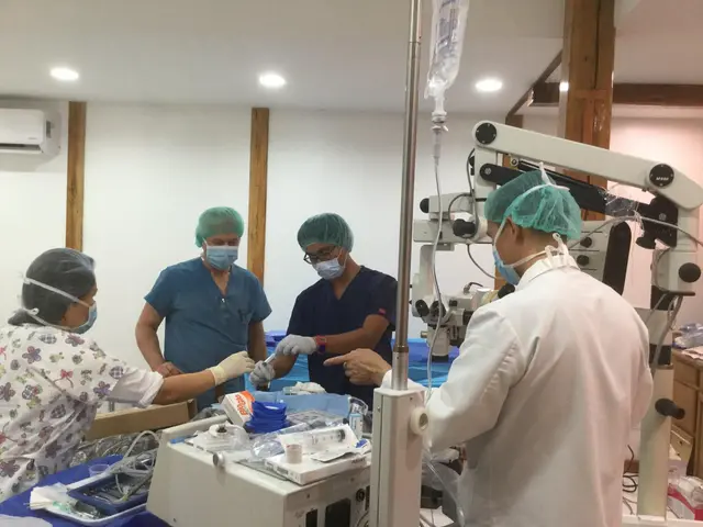 Surgeons in caps and masks performing eye surgery under an operating microscope