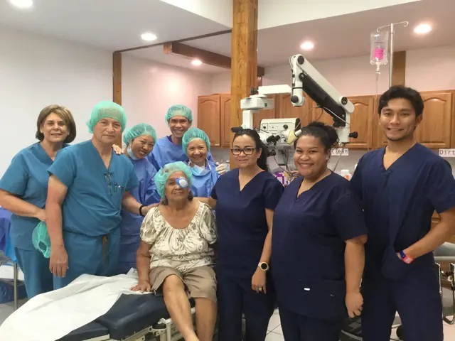 Eye surgery team in scrubs gathered around a smiling elderly patient