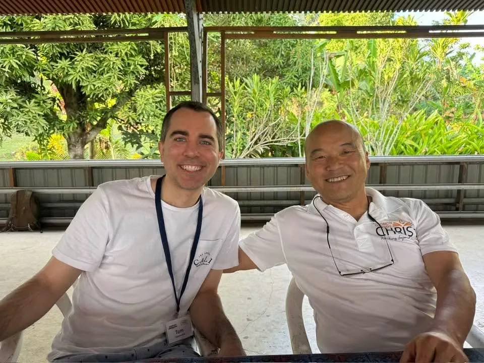 Tom Sliwa and Dr. Steve Chang seated together under a covered outdoor area